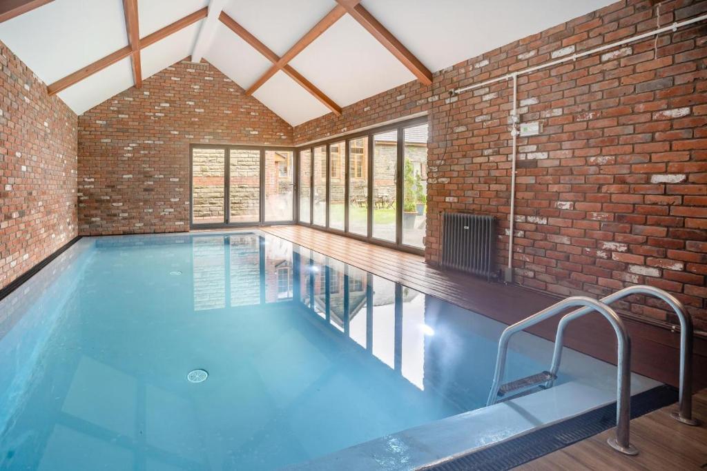 a large indoor swimming pool with a brick wall at 6 Bed in Blaencwm oc-t32688 in Blaencwm