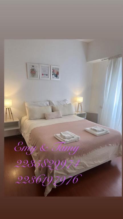 a bedroom with a bed with a neon sign on it at Depto Colón y viamonte in Mar del Plata