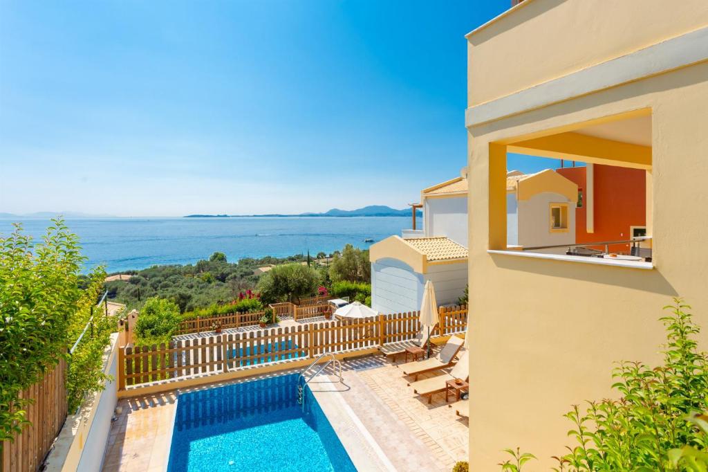 a villa with a swimming pool and a view of the ocean at Villa Sequoia Yellow in Barbati