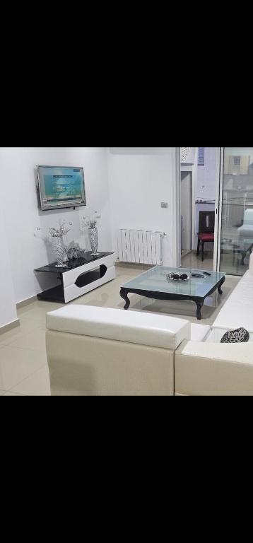 a living room with a couch and a table at Residence fedi 12 in Monastir