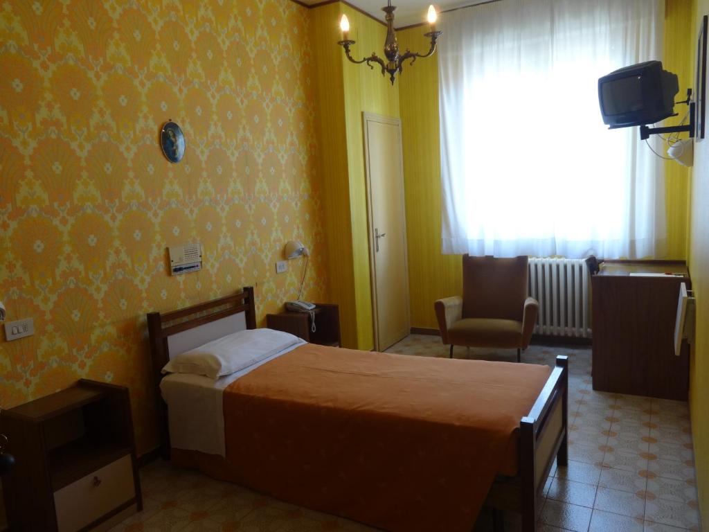 Postel nebo postele na pokoji v ubytování Hotel Saturno