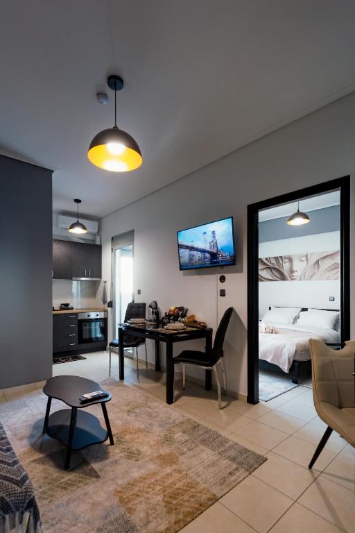 a living room with a desk and a bedroom at Agnanti Apartment in Agrinio