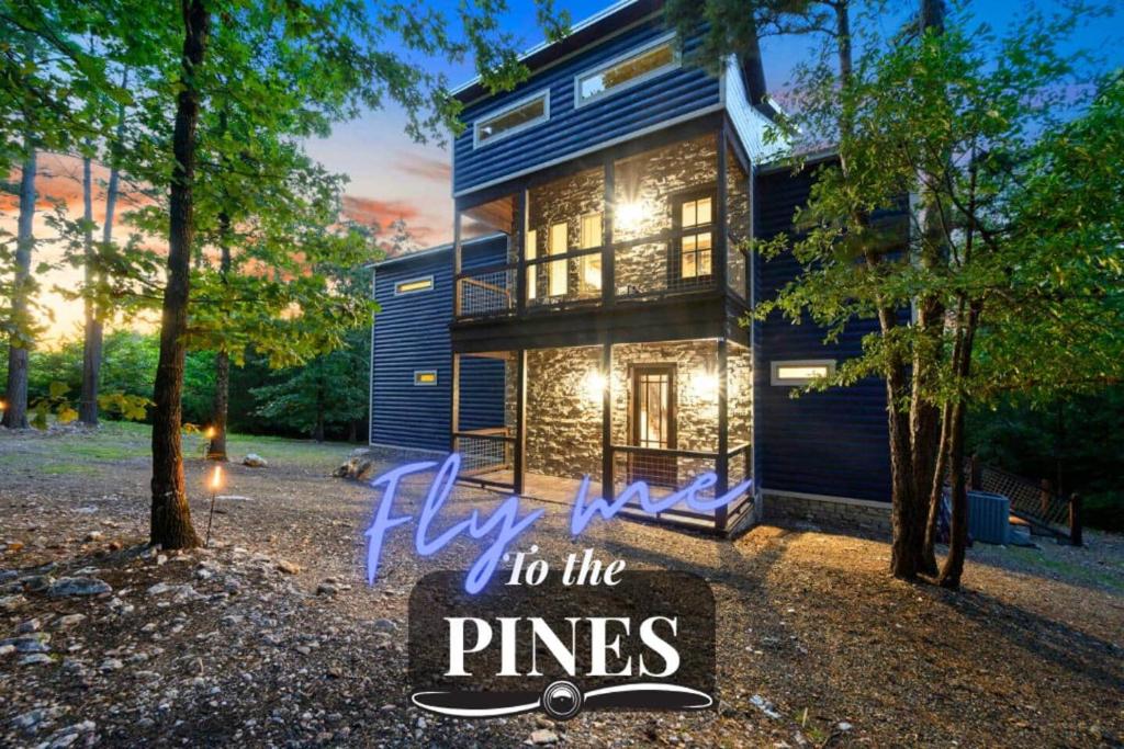 a house with a sign that says fly to the pines at 5 Bedroom - Four En-Suite & Bunk Loft w/half bath in Stephens Gap