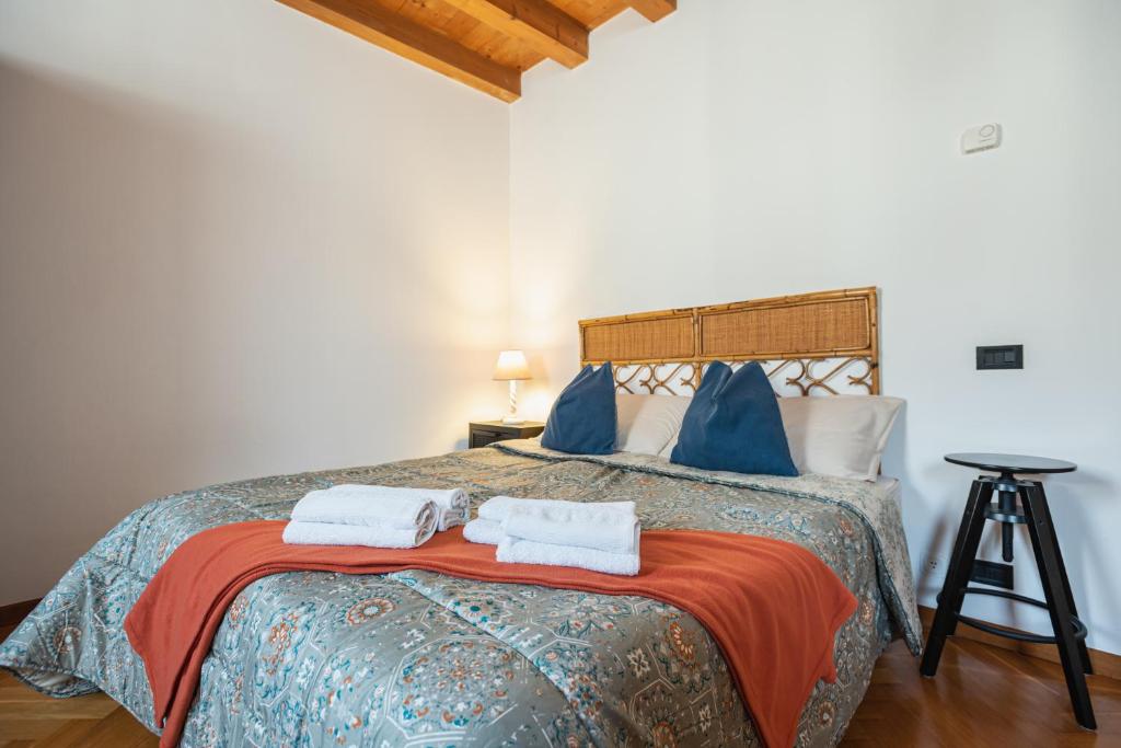 a bedroom with a bed with towels on it at Torre Cà Emo, Il Bilocale "Leone di San Marco" in Vittorio Veneto