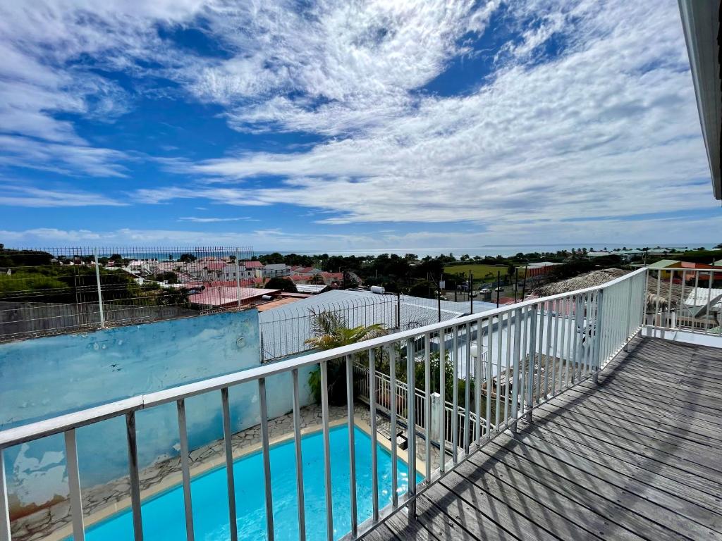 a balcony with a view of a swimming pool at Le Chalet in Saint-François