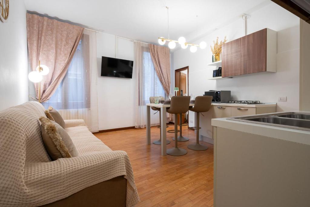 a kitchen and living room with a couch and a table at St Mark's Square - K Collection in Venice