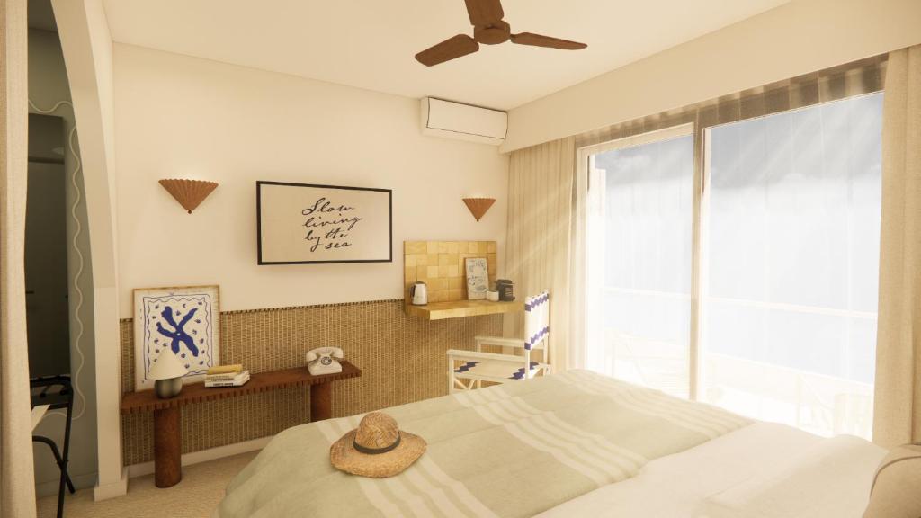 En eller flere senge i et værelse på Hotel Coeur Marin