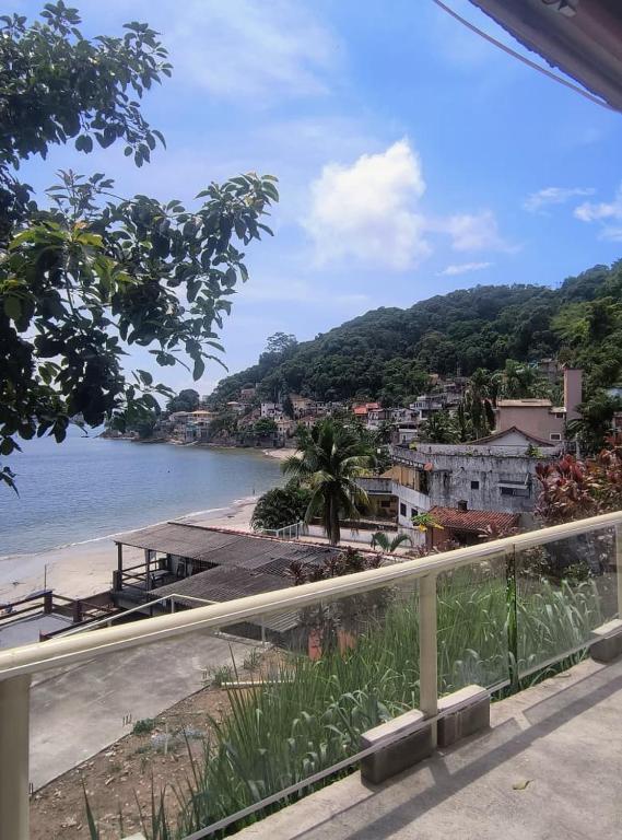 a view of a beach and the ocean from a balcony at Jade Beach Club in São Vicente