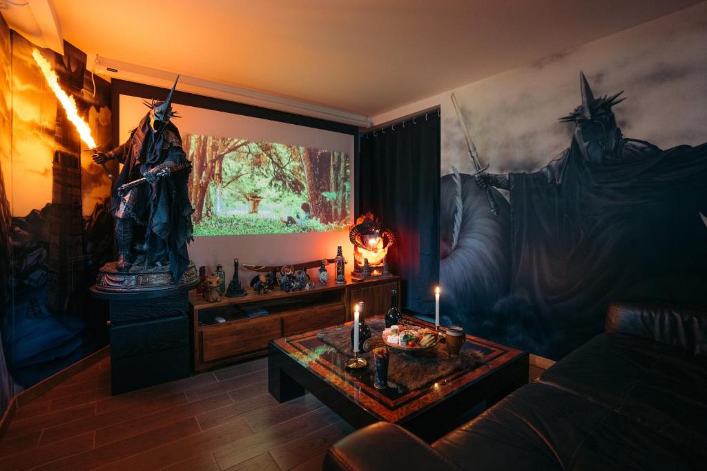a living room with a statue and a table with candles at La Comté à Blagnac Expérience unique seigneur des anneaux , immersion totale proche Toulouse in Blagnac