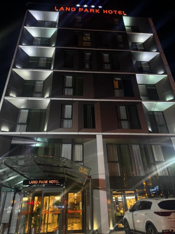 a building with a car parked in front of it at Land Park Hotel in Istanbul