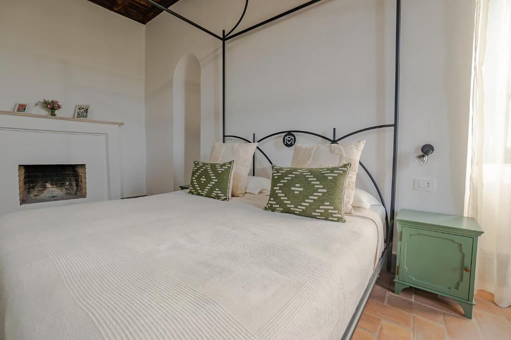 a bedroom with a large white bed with pillows at Casale Malatesta in Velletri