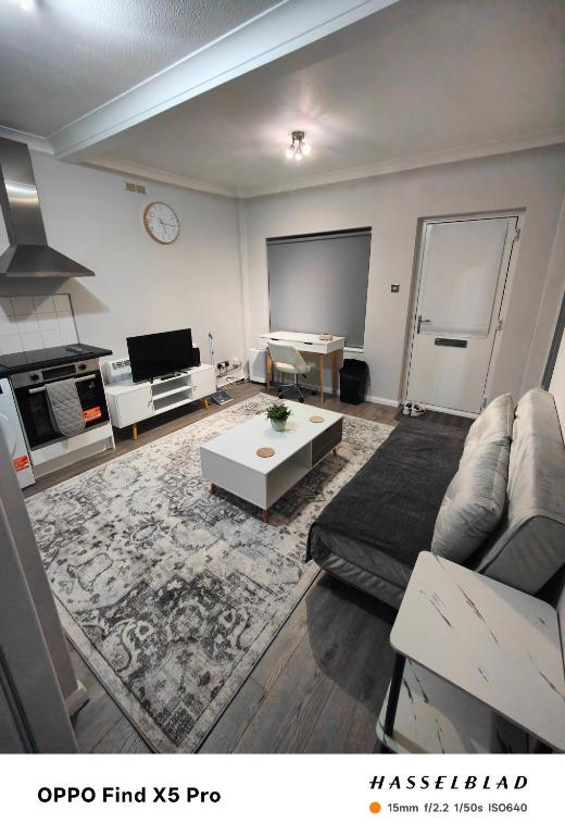 a living room with a couch and a tv at Lovely 1 Bed apartment available in Croxley Green
