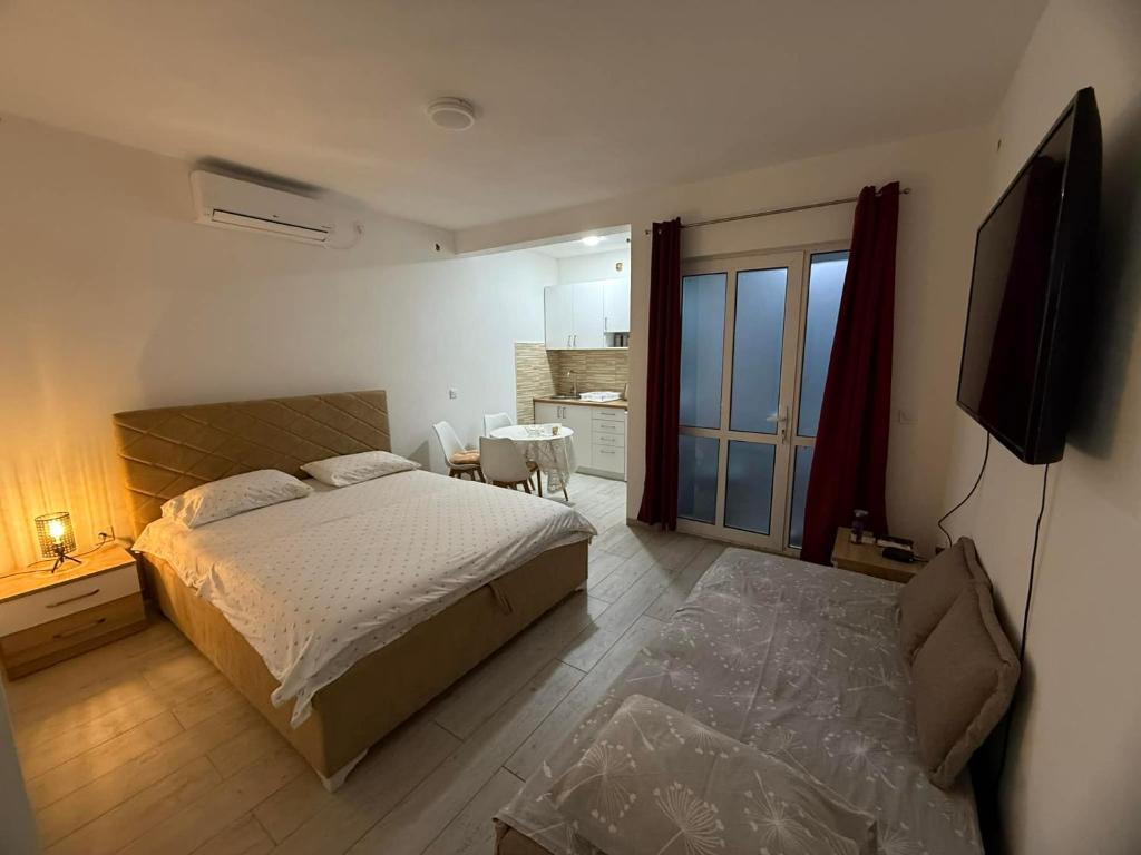 巴尔Apartmani Rajkovic的一间卧室，里面有一张床和一台平板电视