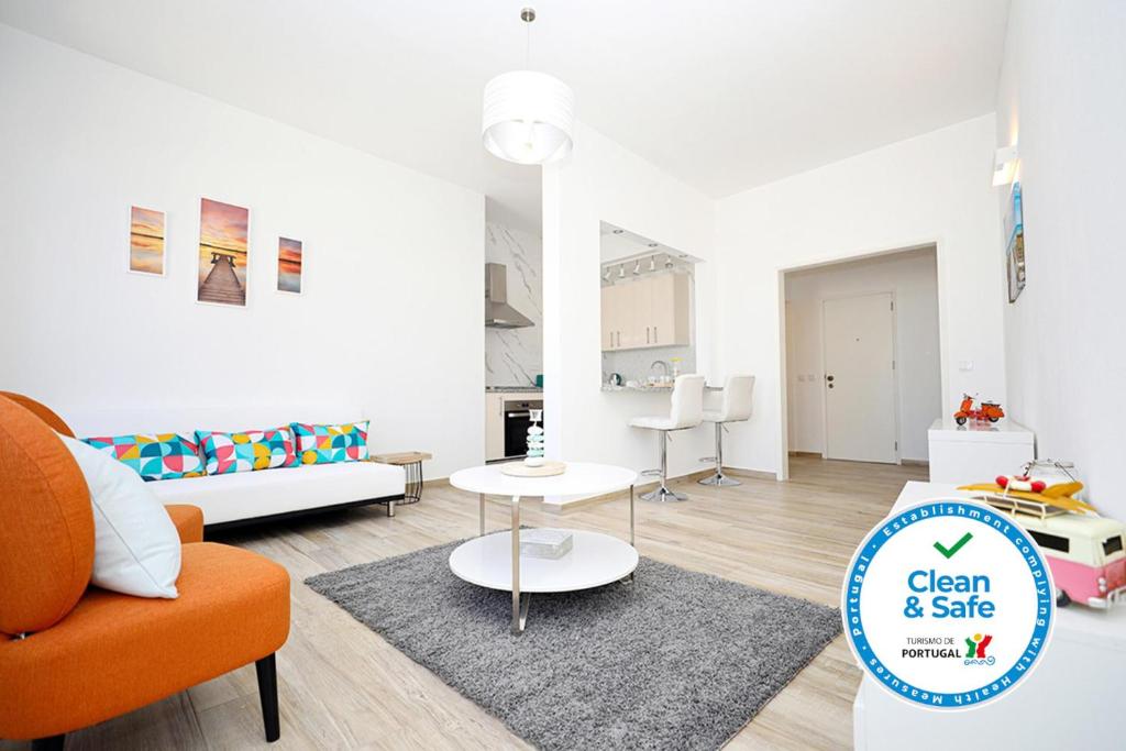 a living room with an orange couch and a table at B50 - Main Square Apartment in Lagos in Lagos