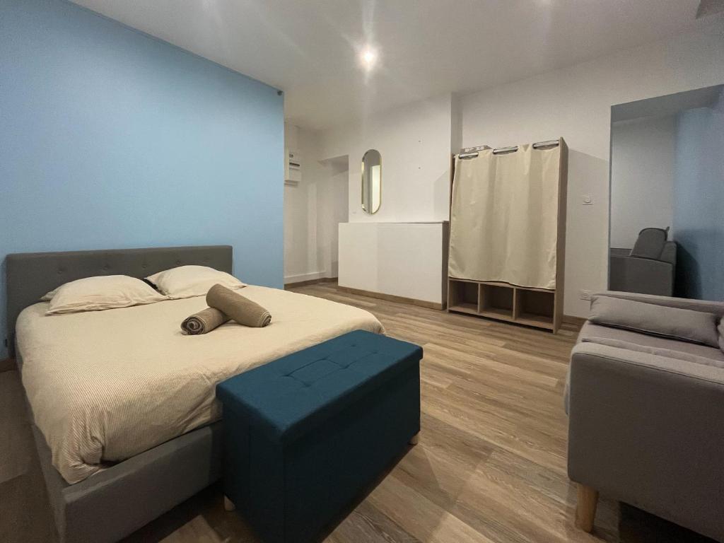a bedroom with a bed with a blue wall at appartement t2 la doutre 2-4 personnes in Angers