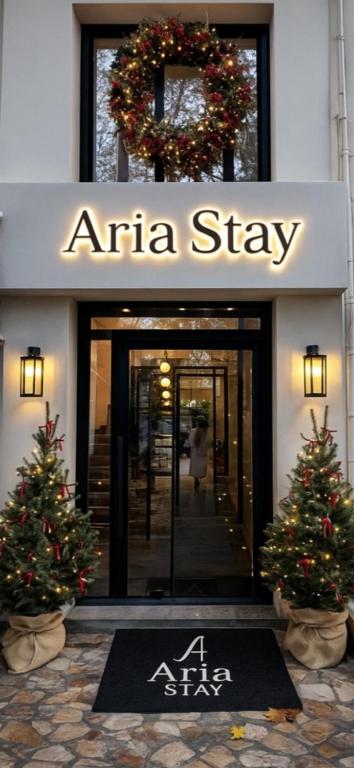 an arma stay sign in front of an entrance to aime star at Aria Stay in Drama