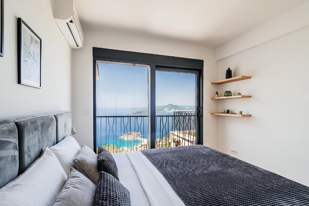 a bedroom with a bed and a large window at The View - Apartment with Pool in Blizikuće
