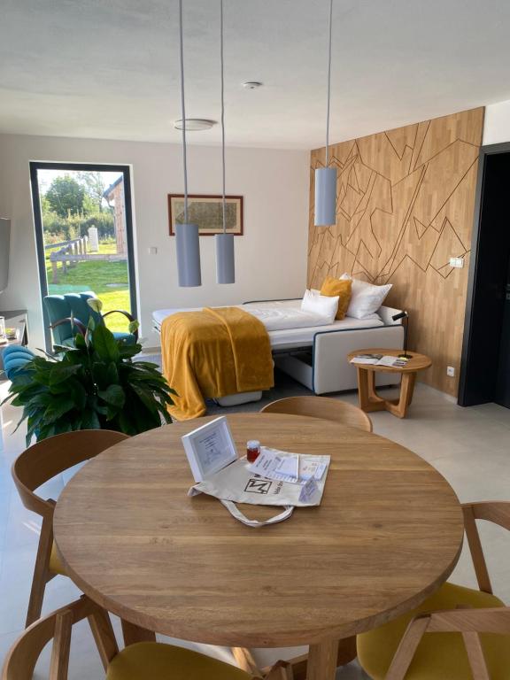 a living room with a table and a couch at Nad Soutokem in Volary