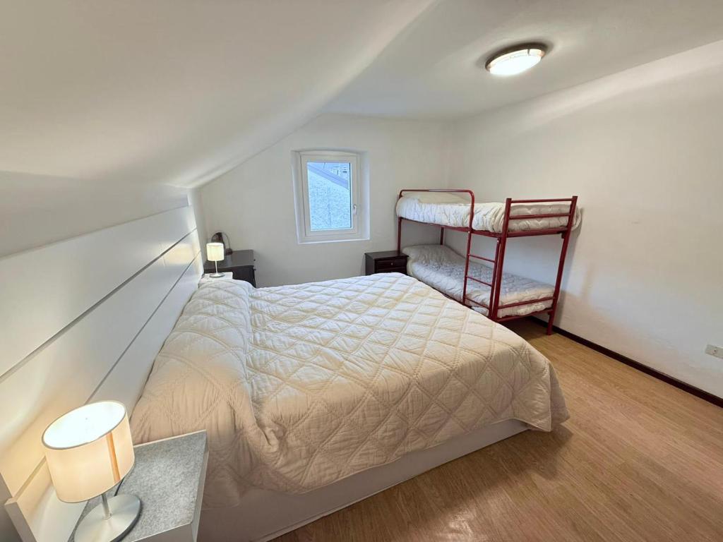 a small bedroom with a bed and a chair at Dimora Donato 2 bedrooms Lauco UD in Lauco