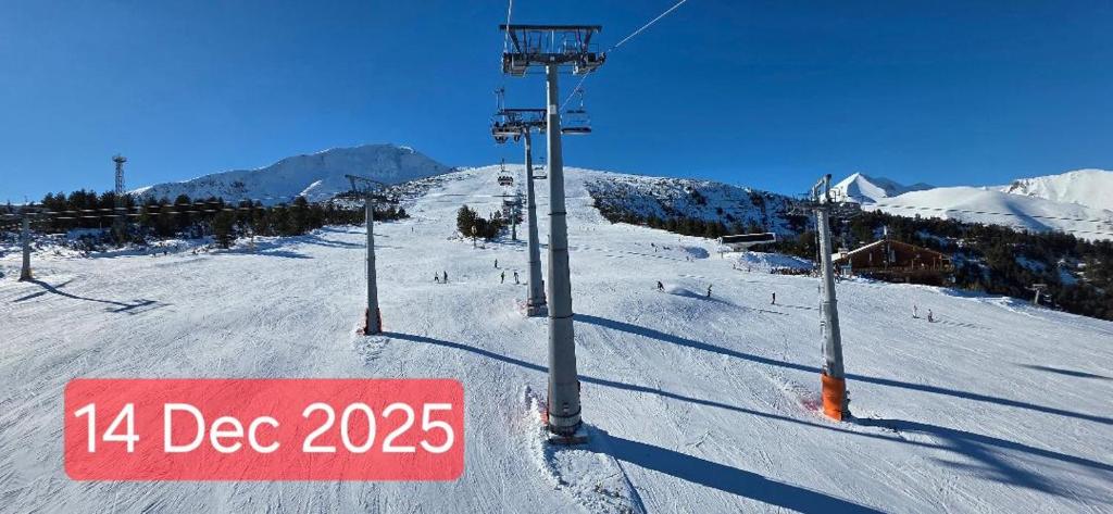 a ski lift with a sign in the snow at Penthouse Harriet Bansko in Bansko