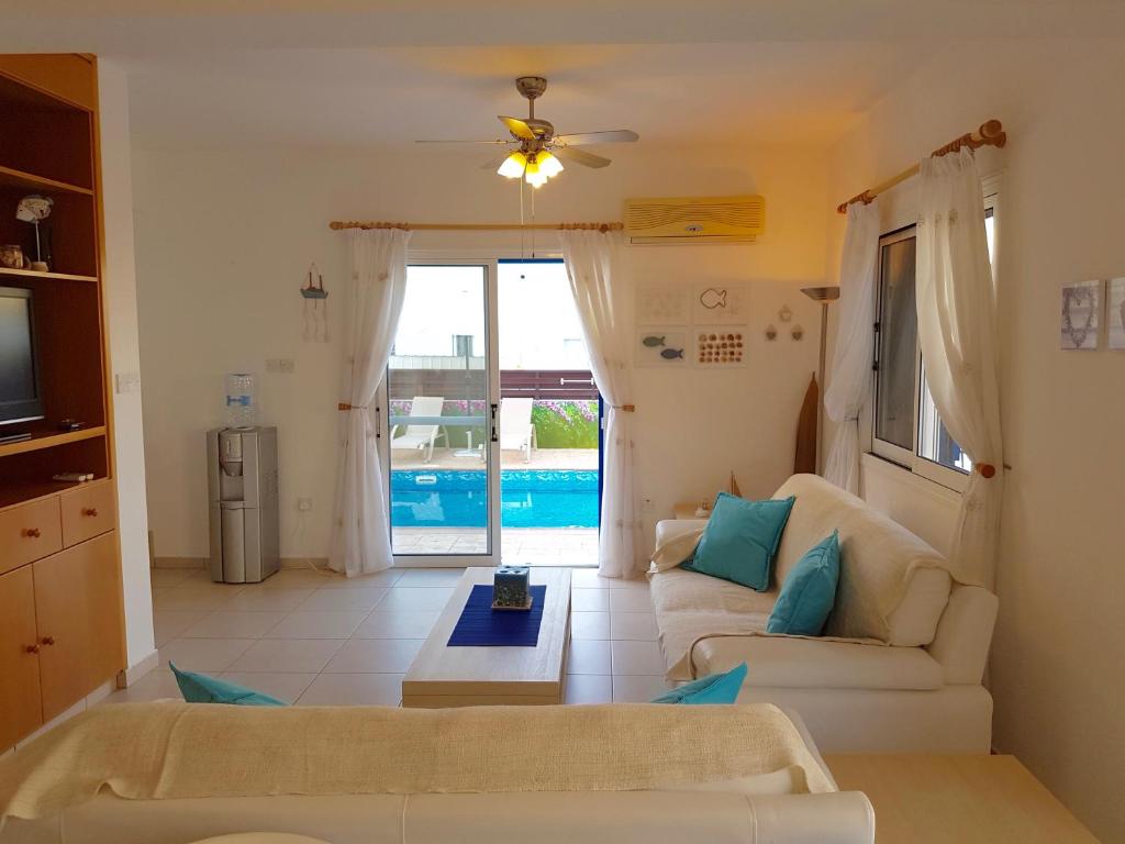 a living room with a couch and a tv at Villa Charlotte in Protaras