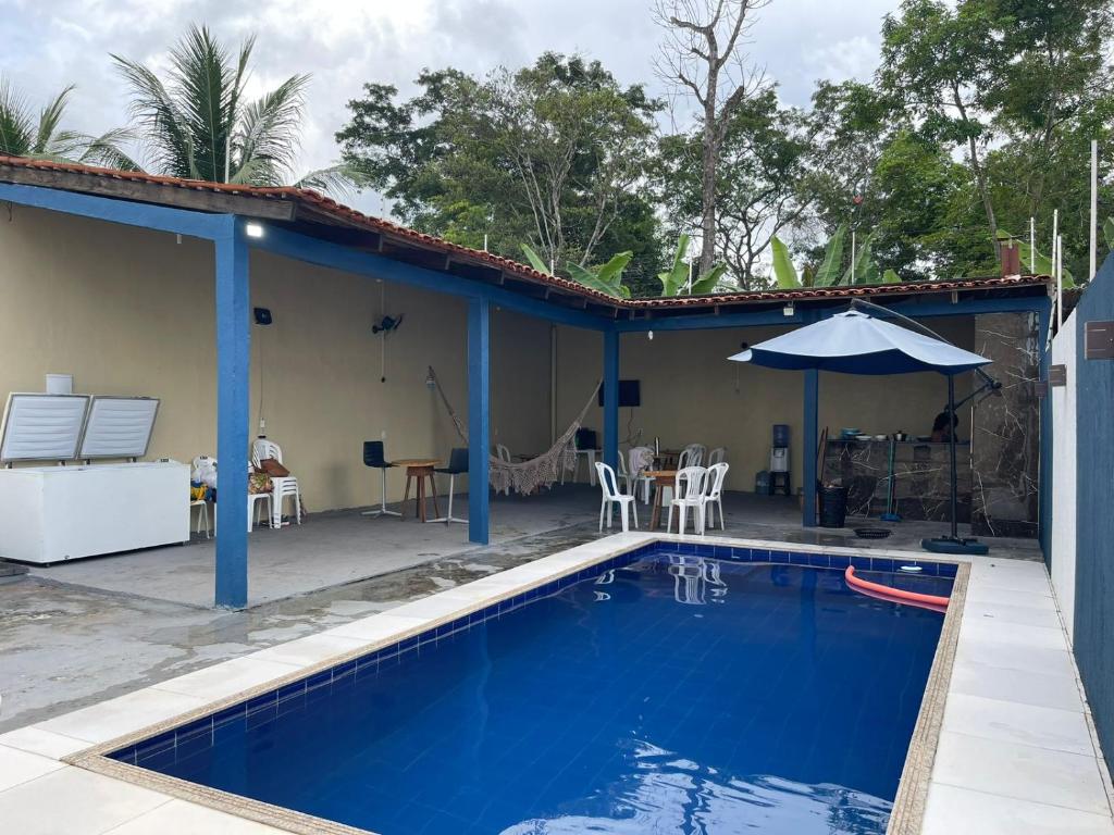 a house with a swimming pool and a patio at Casa TDM 2 in Macapá