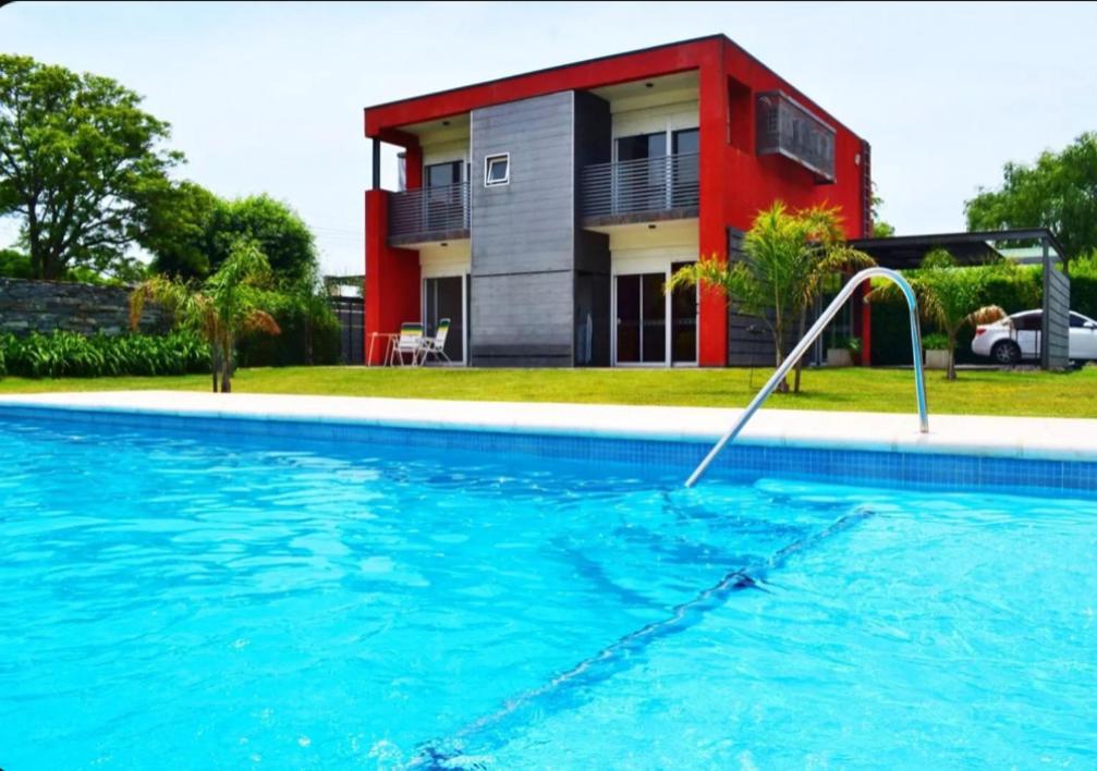 een zwembad voor een huis bij Rumipaz in Villa Rumipal