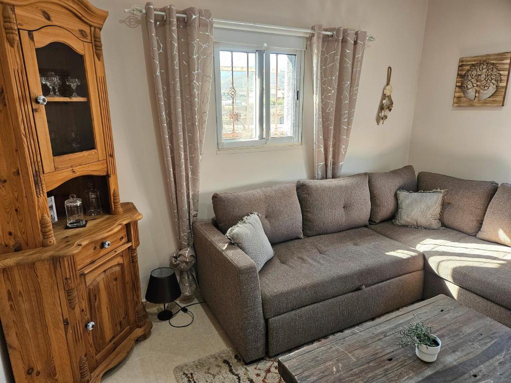 ein Wohnzimmer mit einer Couch und einem Fenster in der Unterkunft Casa Las Patas De Los Patos in La Sabinita