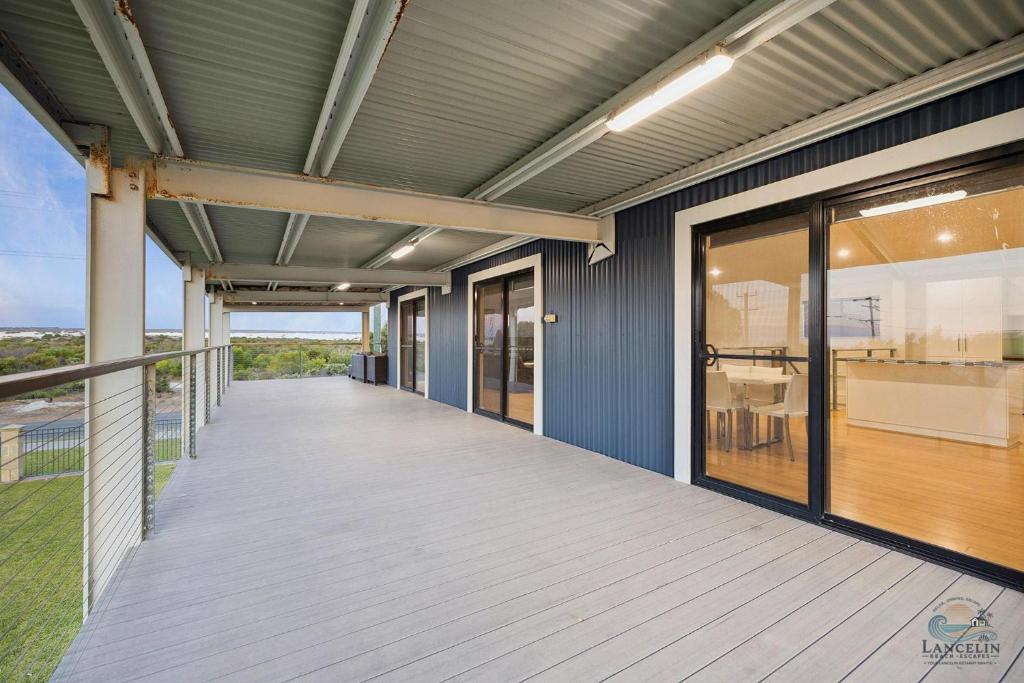 a covered porch of a house with a view at Dune View in Lancelin