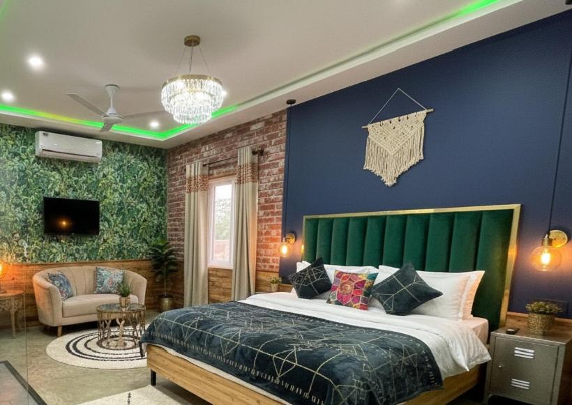 a bedroom with a large bed with a green headboard at Star Residency Hotel in Islamabad