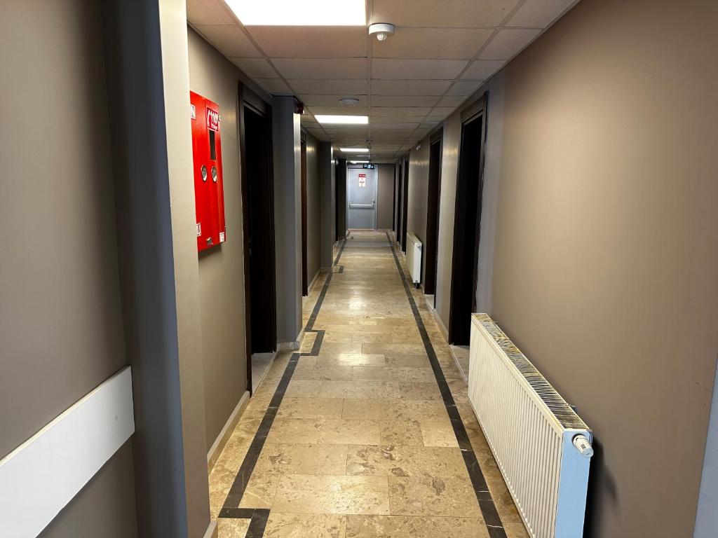 a corridor of a hallway with a long hallway at Big Inn Luxury Hotel in Biga