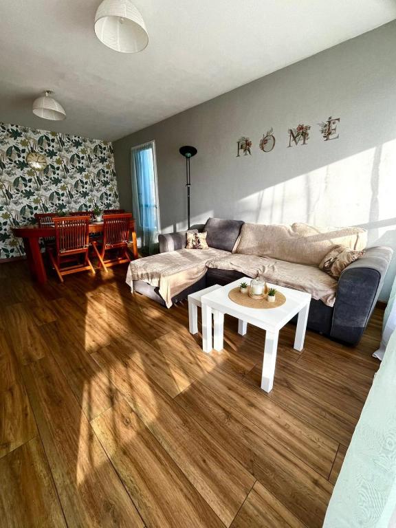 a living room with a couch and a table at Home in Cenon in Cenon