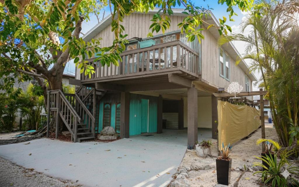 a house with a deck on the side of it at Anna Maria Island Tree House Pet Friendly! in Bradenton Beach