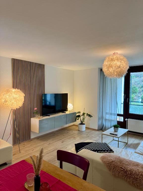 a living room with a couch and a flat screen tv at Ferienwohnung No 5`2 Rottweil in Rottweil