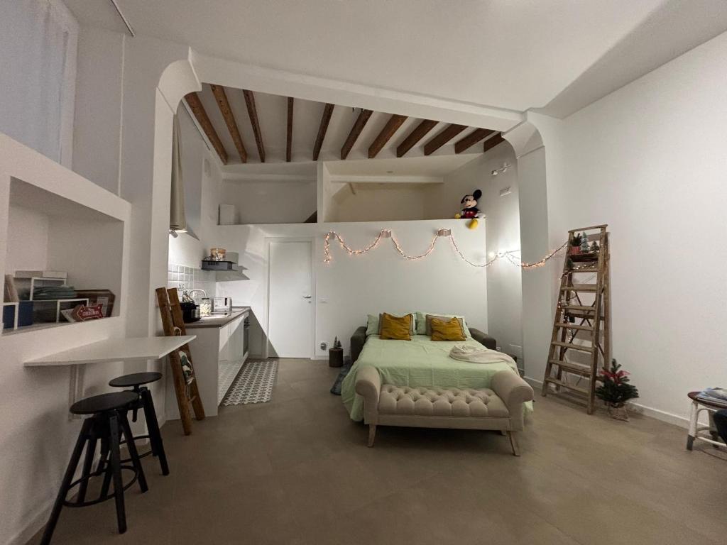 a bedroom with a bed and a desk and a ladder at Cà du Local in Arenzano