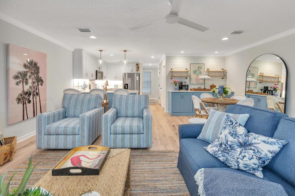 a living room with two blue couches and a kitchen at Demere Landing #162 in Saint Simons Island