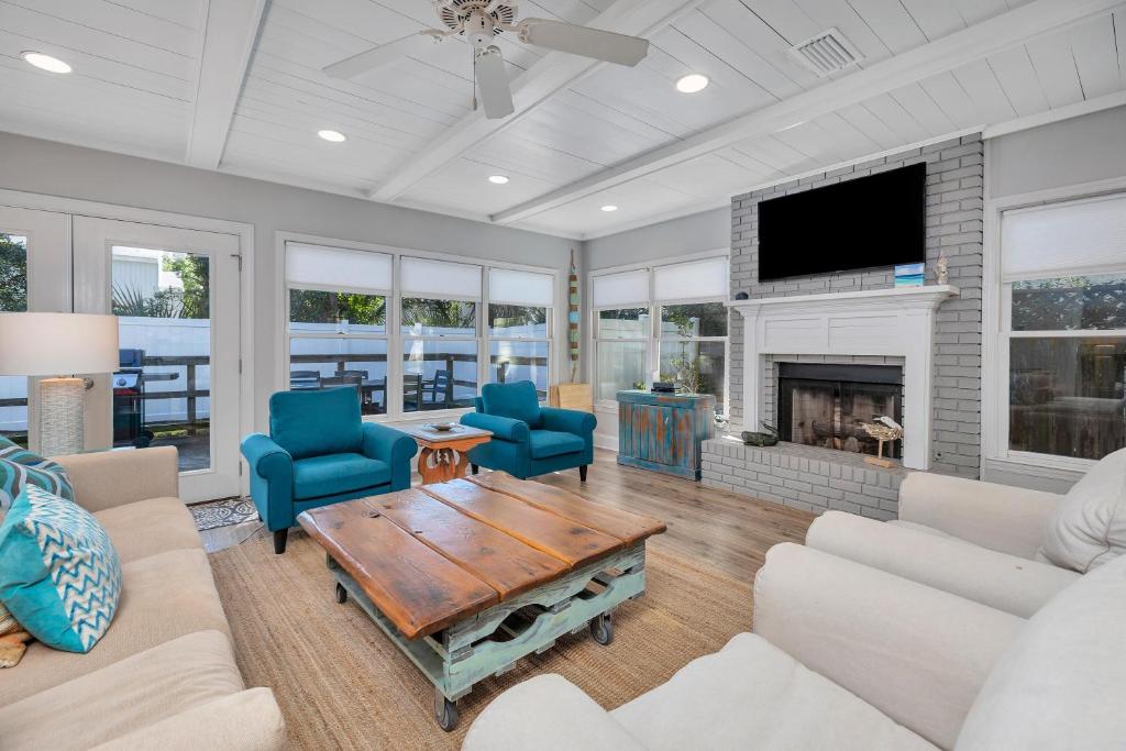 a living room with blue chairs and a fireplace at 1126 Park Lane in Demere Park