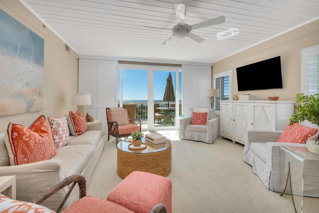 a living room with a couch and a ceiling fan at St. Simons Grand #325 in East End