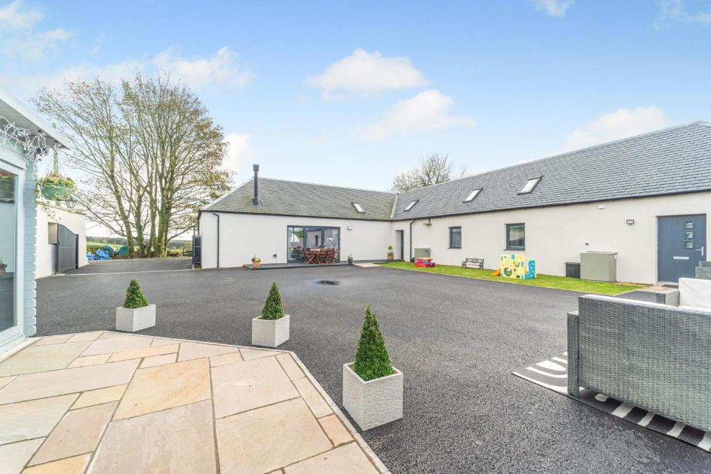 a house with a driveway in front of it at 5 Bed in Galston oc-s33451 in Galston