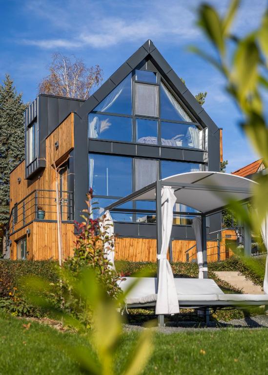 a glass house with a mattress in front of it at LoveNest Hungary in Győrújbarát
