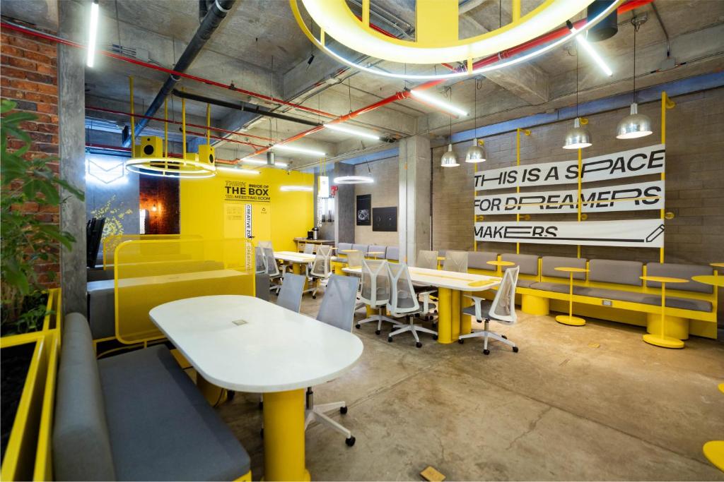 Un restaurante con mesas y sillas en una sala. en Indie Universe Creative Hotel, en Medellín