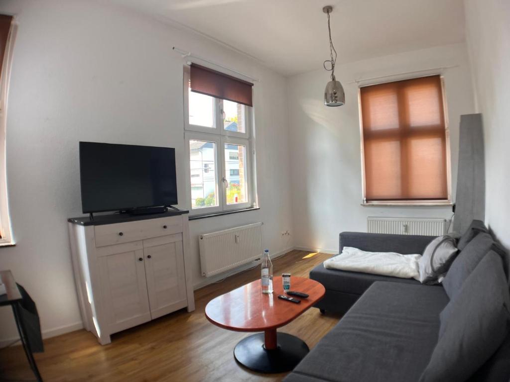 a living room with a couch and a table at Gästehaus urucu in Bornheim