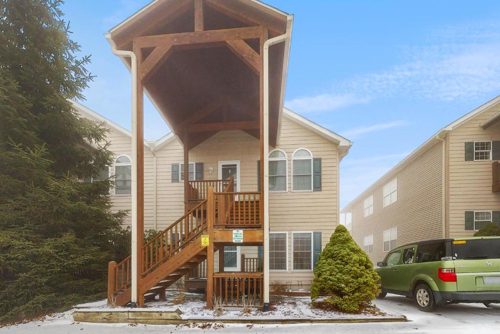 a house with a large wooden staircase in front of it at Klonteska B5 in Beech Mountain