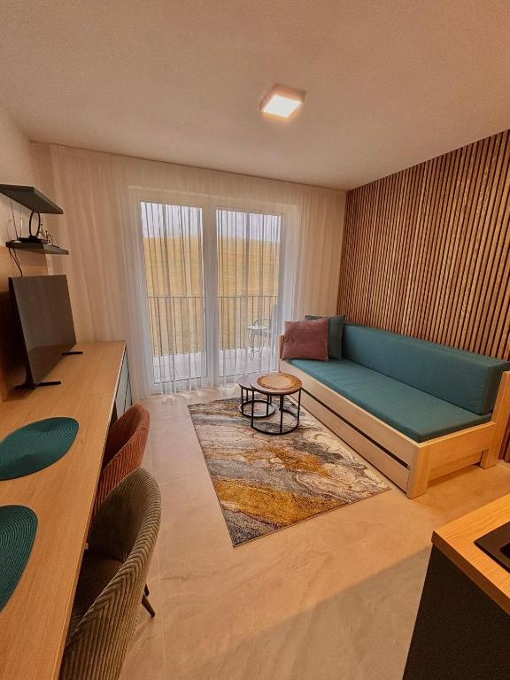 a living room with a couch and a table at Apartmán nad Dolným Kubínom in Dolný Kubín