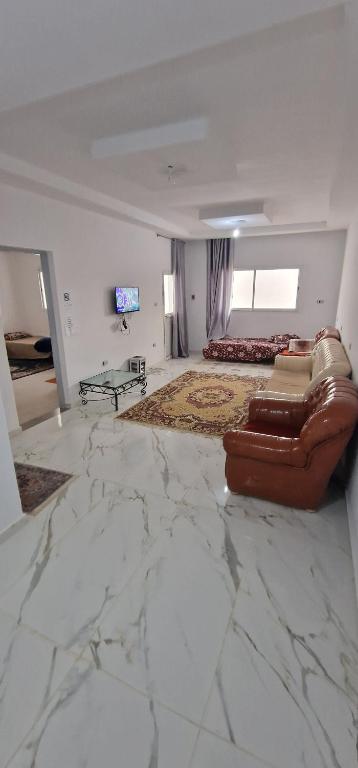 En eller flere senge i et værelse på Appartement centre ville medenine