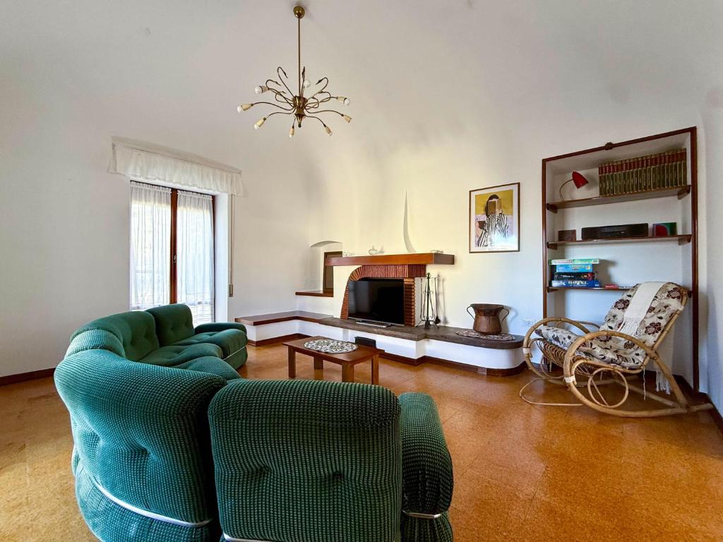 a living room with a couch and a fireplace at Casa Felice 1910 in Introdacqua