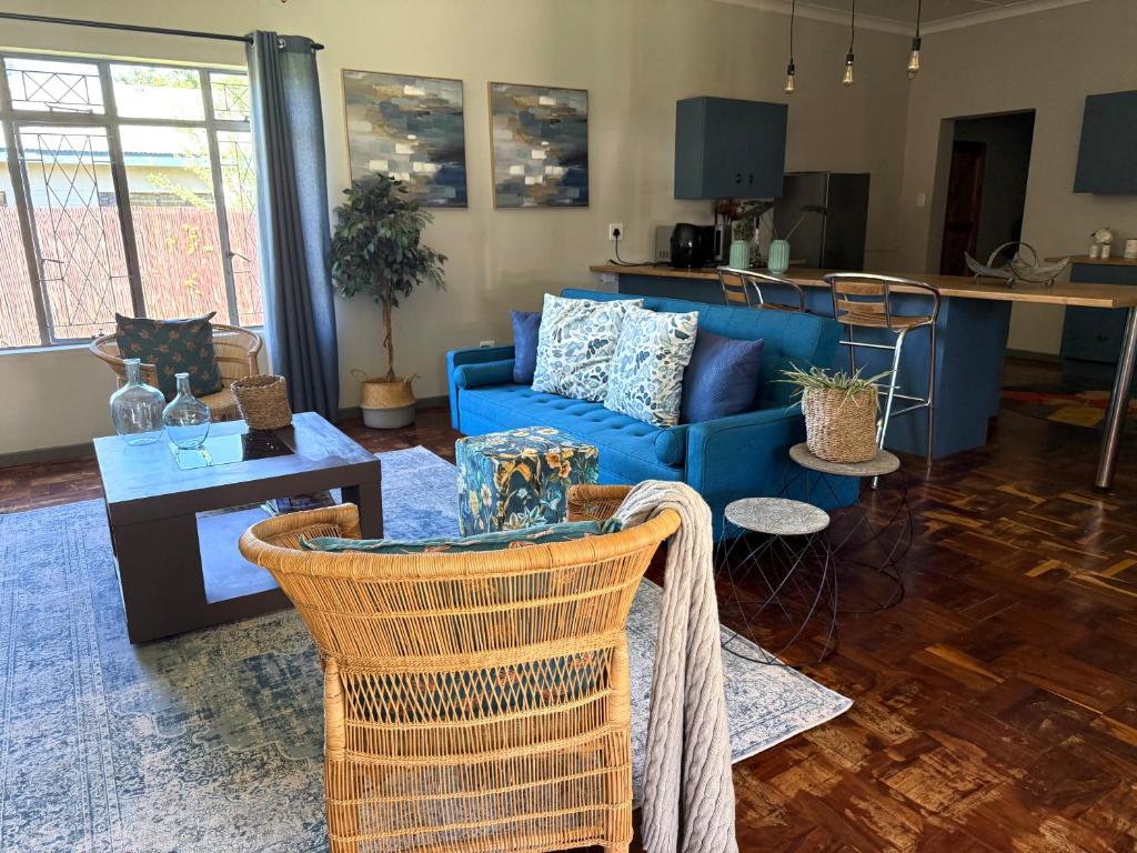 a living room with a blue couch and a table at Lilibeth guesthouse in Parys