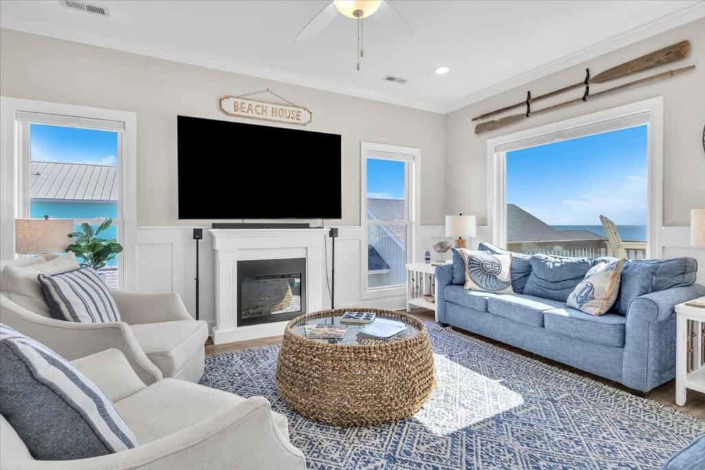 a living room with a blue couch and a tv at Shore Bet in Surf City