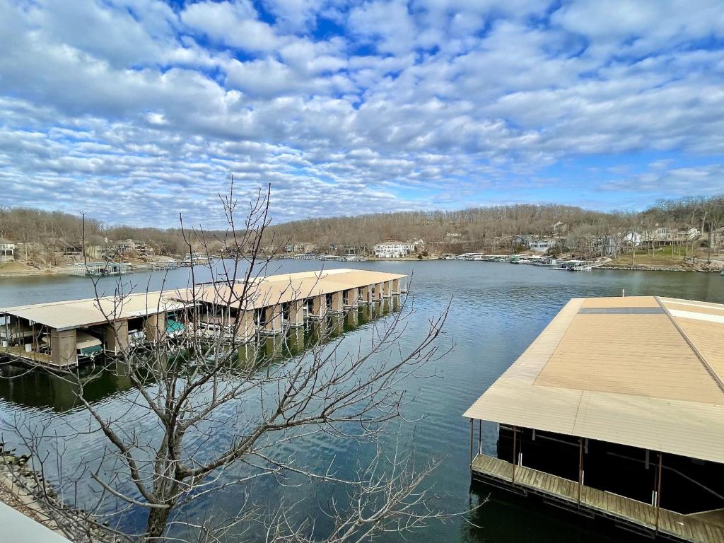 a dock on a body of water with a sky at Baypoint Condo, Pool, Dock, relaxing location in Lake Ozark