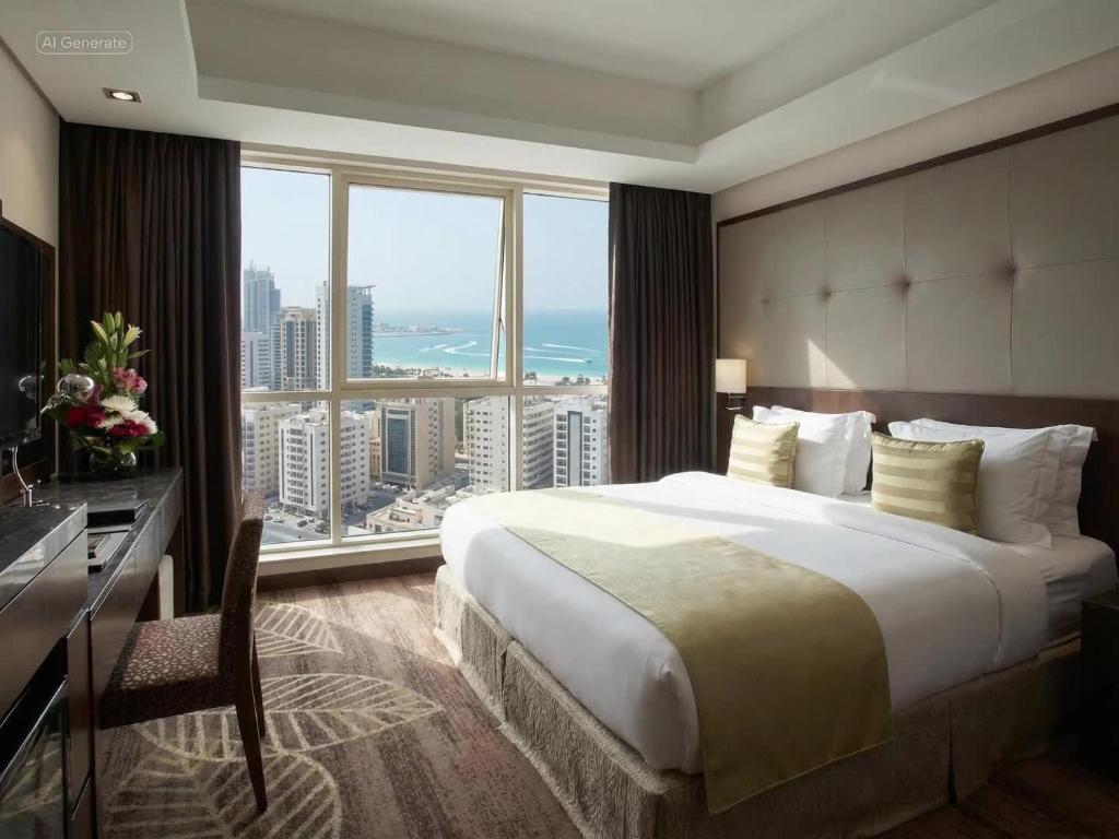 a hotel room with a large bed and a large window at Ramee Rose Hotel in Manama
